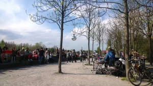 Mauerpark in Berlin on a Sudany afternoon - People and Music. Photo by Giuseppe Govinda enhanced with AI